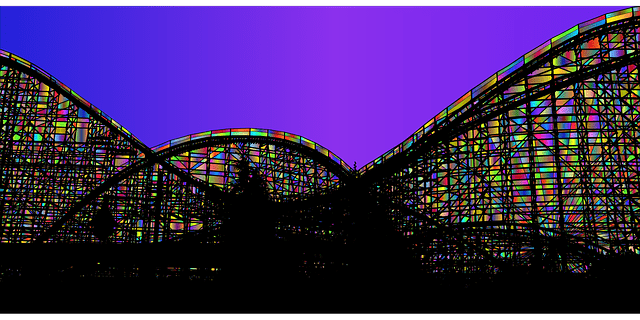 A roller coaster in silhouette, with the open spaces in the structure filled in rainbow colors. Running and indie press is a lot like riding a roller coaster!