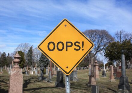 The yellow traffic sign placed just in front of a cemetary says OOPS! No character-driven fiction here, sorry!