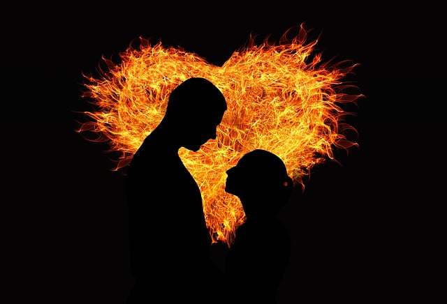 How to Write a Slow Burn Romance in Fantasy Fiction The silhouettes of a man and a woman backlit by a fiery heart. This depicts slow burn romance at its best!